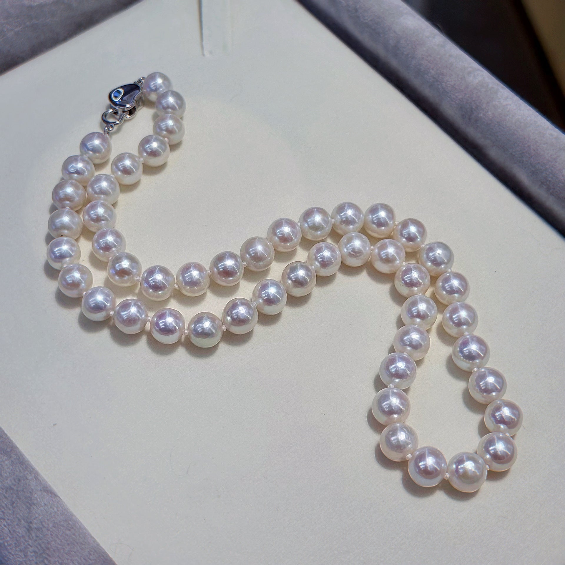 AAA+ Pearl necklace on a light surface