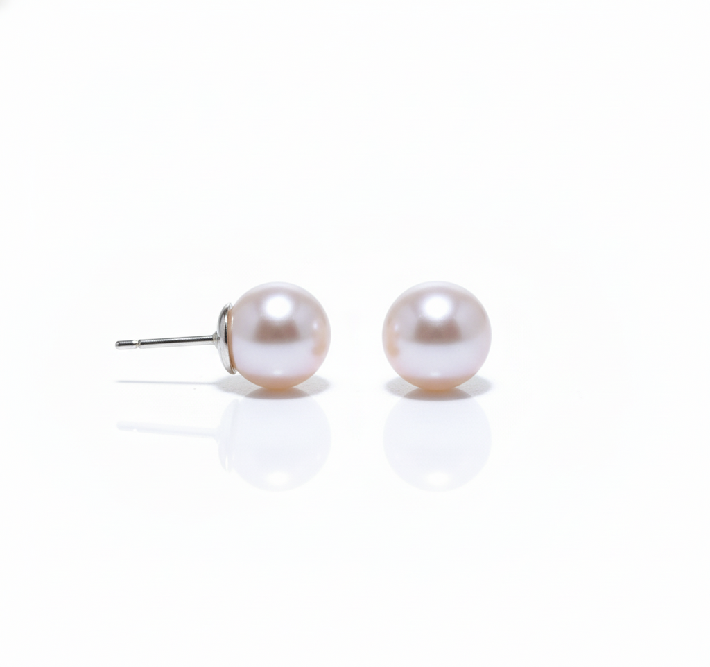 Side view of pearl stud earrings on white background