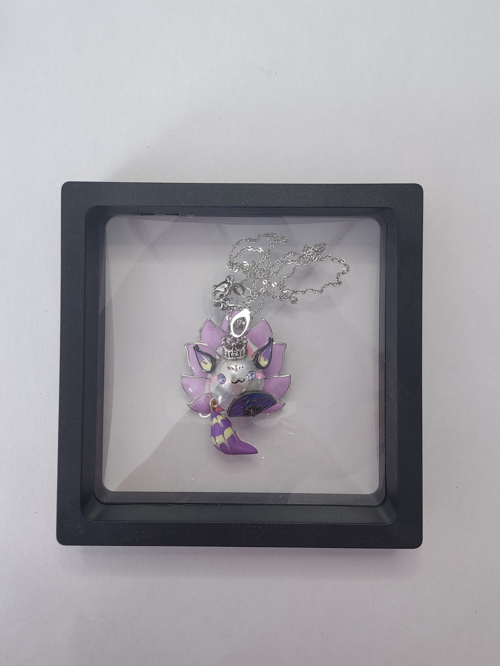 Baroque pearl fox pendant displayed on clear jewelry packaging box