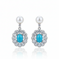Pearl turquoise drop earrings with zirconia on white background