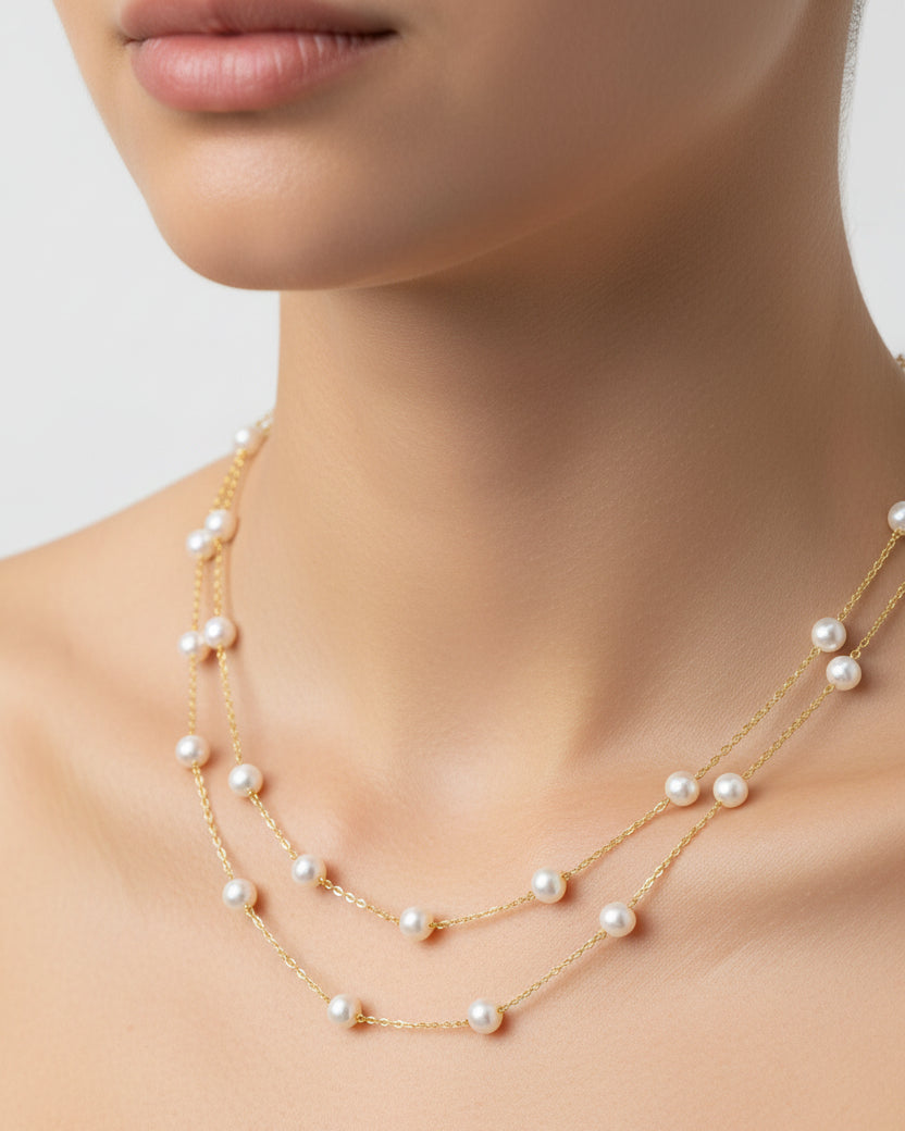 Pearl necklace on a model against a neutral background