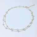 Double-layered pearl necklace on a light background